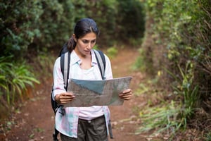 Woman hiking through a forest in the countryside